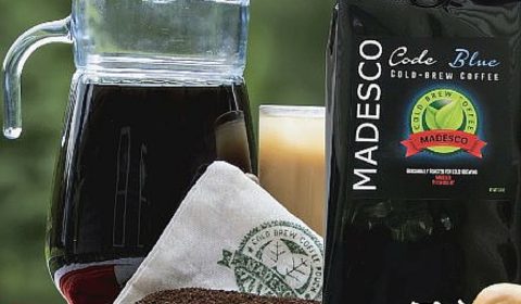 A picture of Madesco Coffee grounds and a pitcher of iced coffee